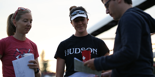 Row Ontario domestic manager Kate Savage with coaches at rowing event.